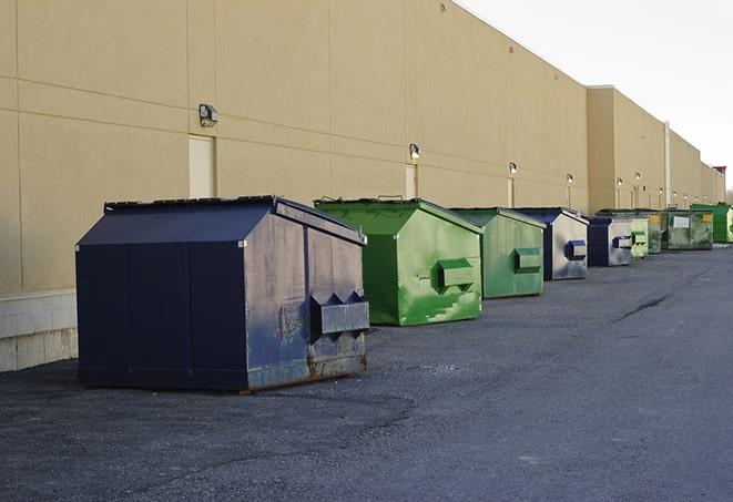 a group of construction workers taking a break near a dumpster in Beech Grove